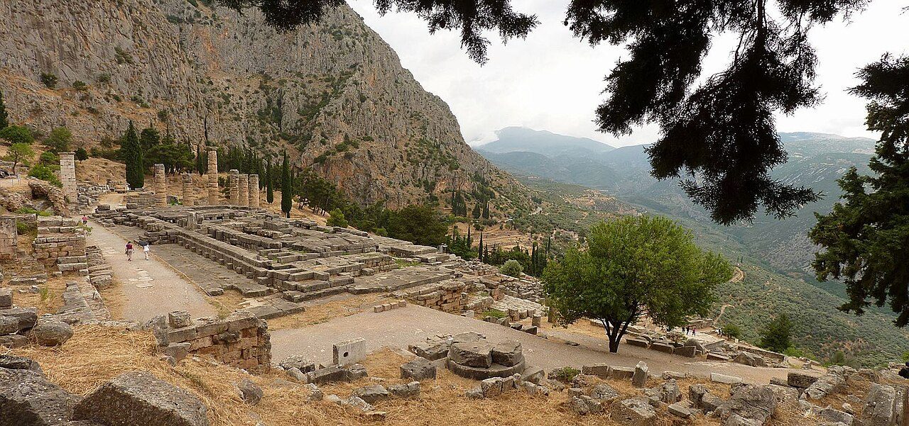 The surviving columns of the Temple of Apollo at Delphi, built into the slope of Mount Parnassus above the Gulf of Corinth.