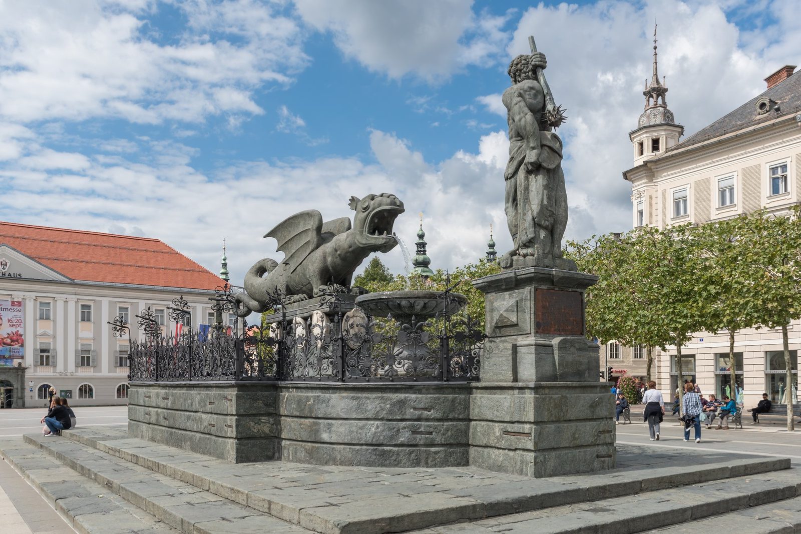 The Lindwurmbrunnen (Dragon Fountain) in Klagenfurt, Austria, showing the stone dragon sculpture with its head modeled directly on an Ice Age woolly rhinoceros skull discovered in 1335.