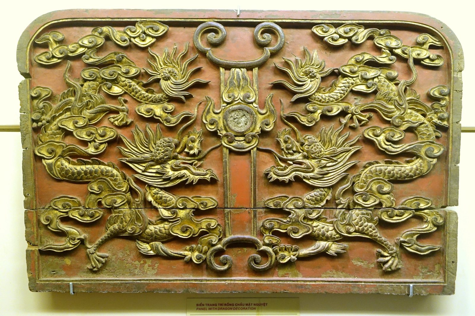 A gilded wood panel showing two dragons flanking a moon disc, a motif called rồng chầu mặt nguyệt, Nguyễn dynasty, 19th century, National Museum of Vietnamese History, Hanoi.