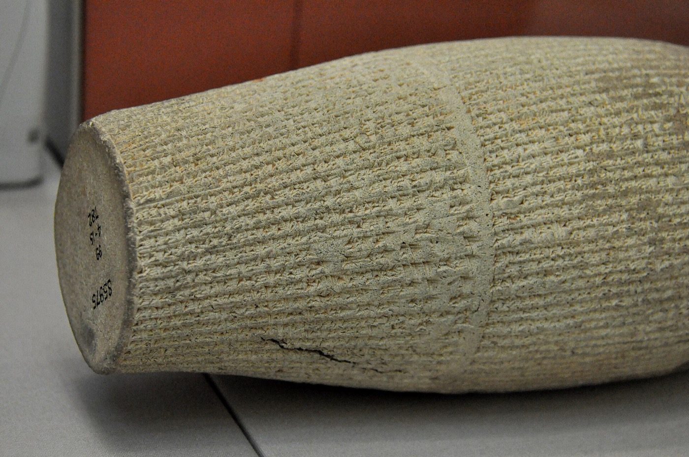 Close view of a terracotta cylinder of Nebuchadnezzar II in the British Museum, covered end to end in cuneiform recording his building and restoration work at Babylon. Hundreds of inscriptions like this survive, and none of them describes a garden.