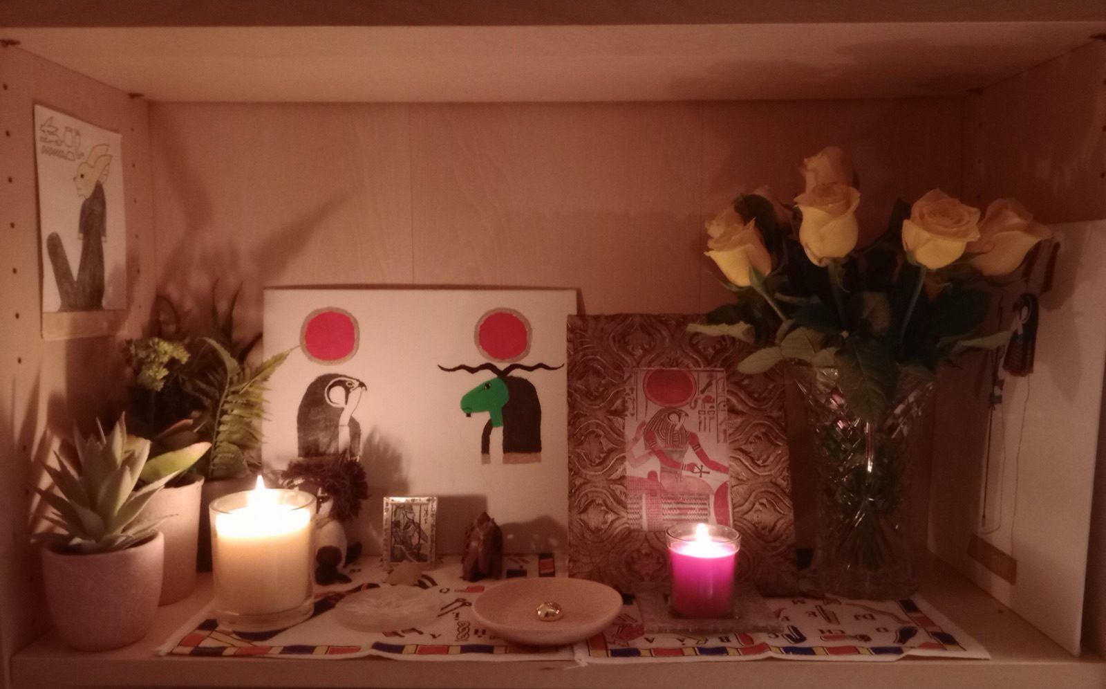 A modern private Kemetic altar with a statue and an incense offering dedicated to the god Horus, photographed in 2023.