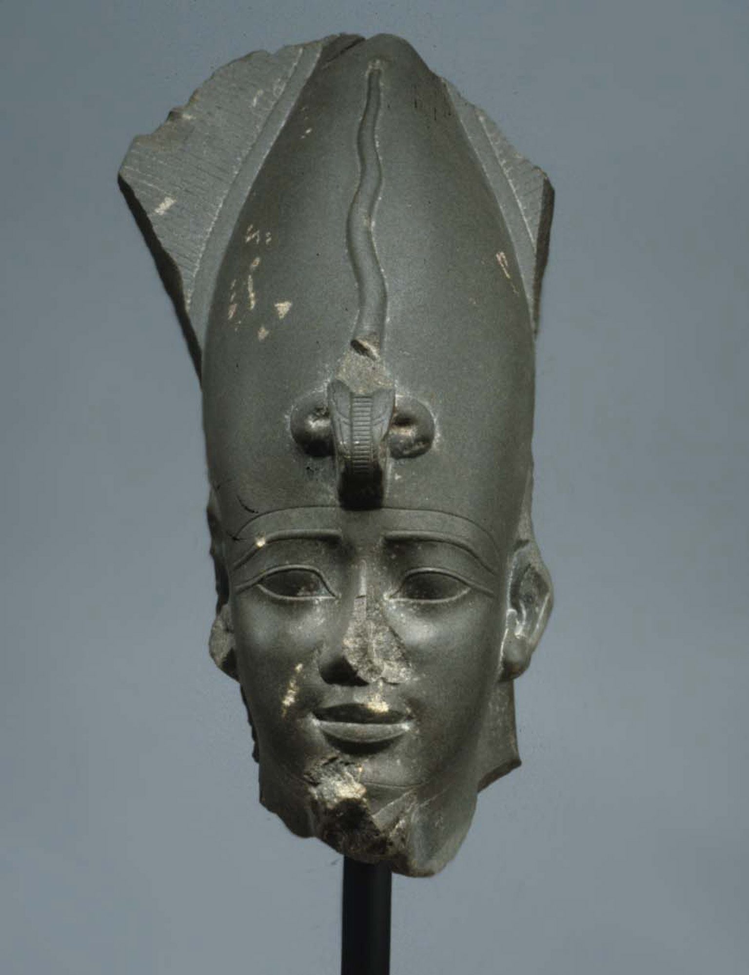 A sculpted head of Osiris wearing the Atef crown, the white Hedjet crown of Upper Egypt flanked by two curled ostrich feathers, from the Metropolitan Museum of Art's collection.