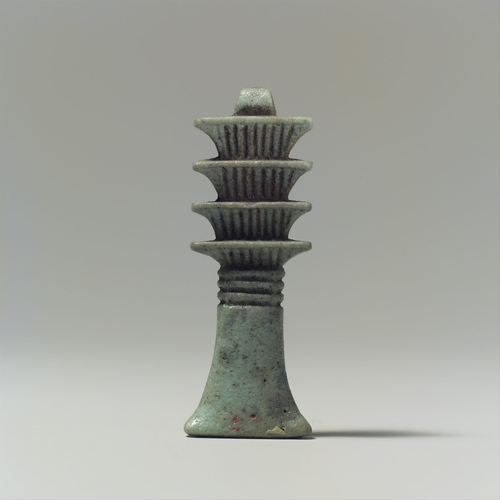 A small Egyptian djed pillar amulet, the pillar-shaped symbol of stability later associated with Osiris's backbone, from the Metropolitan Museum of Art's collection.