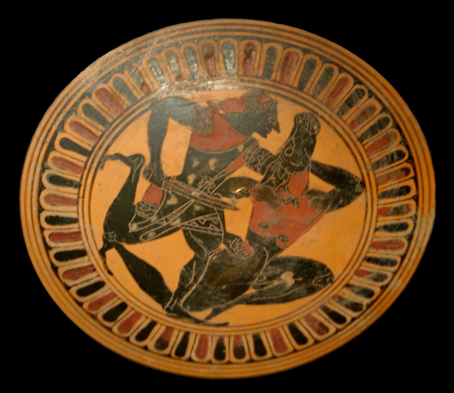 Attic black-figure kylix tondo, about 450-440 BC, showing Theseus gripping the fallen Minotaur by the horn in a wrestling hold, with no weapon visible. Musee du Louvre, F83, Campana Collection.