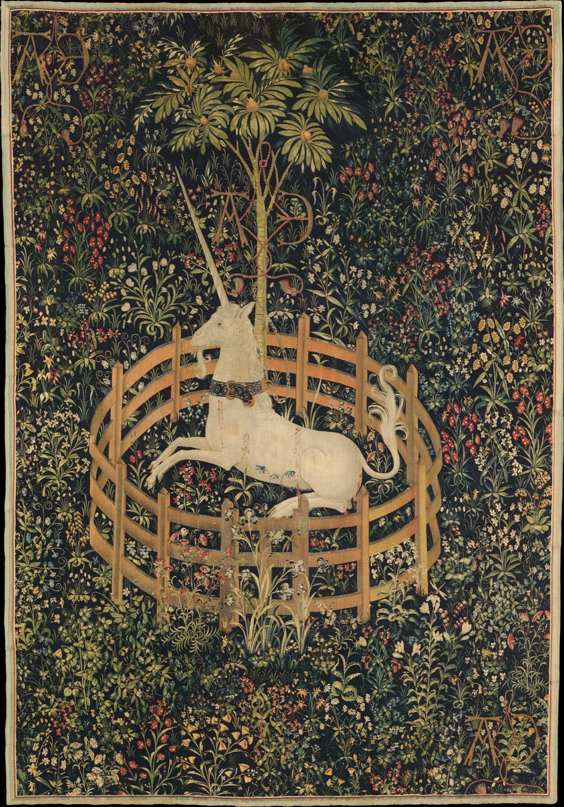 The final panel of The Hunt of the Unicorn tapestry series, showing a white unicorn resting inside a low circular fence in a flowering meadow, chained loosely to a pomegranate tree.