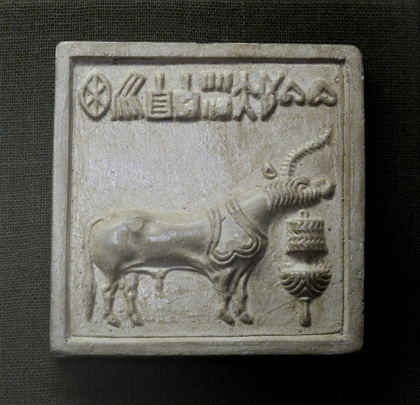A carved steatite seal from the Indus Valley Civilization, roughly 2600 to 1900 BCE, showing the single-horned "unicorn" motif in profile above a ritual offering stand, now held at the Chhatrapati Shivaji Maharaj Vastu Sangrahalaya in Mumbai.